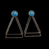 Image of faceted blue earrings with two, thin gold plated, overlapping triangles underneath, on a black background.