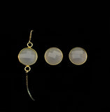 Image of grey sea glass bracelet and matching stud earrings on a black background.