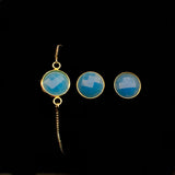 Image of blue sea glass bracelet and matching stud earrings on a black background.