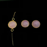 Image of pink sea glass bracelet and matching stud earrings on a black background.