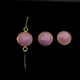 Image of mauve sea glass bracelet and matching stud earrings on a black background.