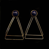 Image of lapiz lazuli earrings with two, thin gold plated, overlapping triangles underneath, on a black background.